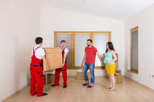 Moving boxes and furniture in a Kingston upon Thames property